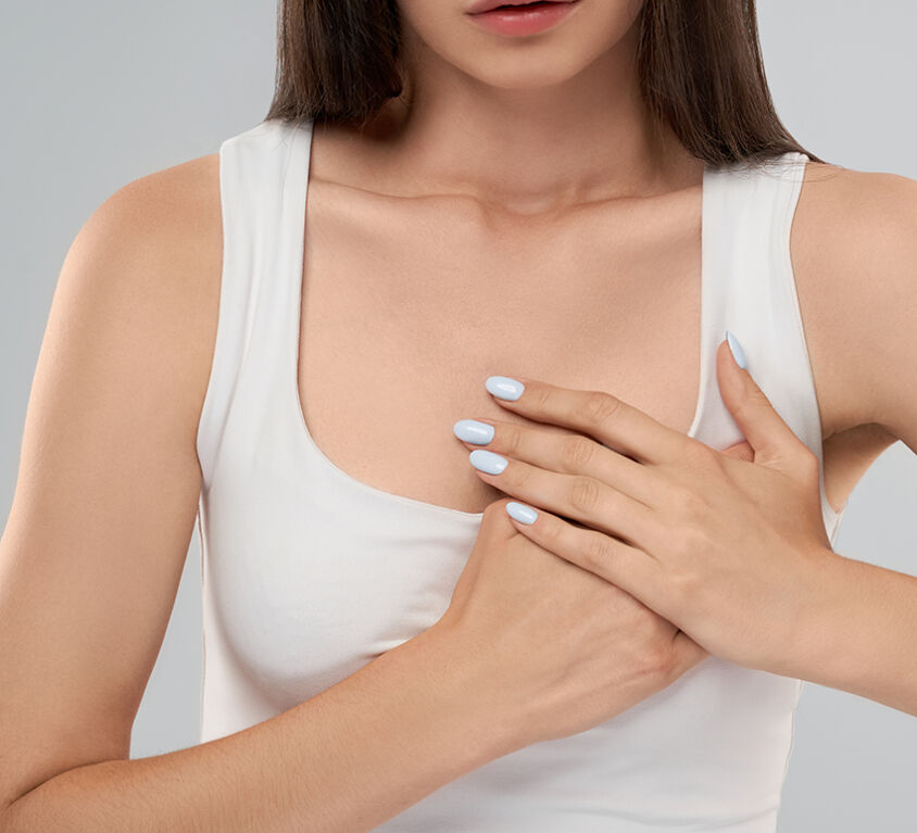 Woman showing pain in chest.